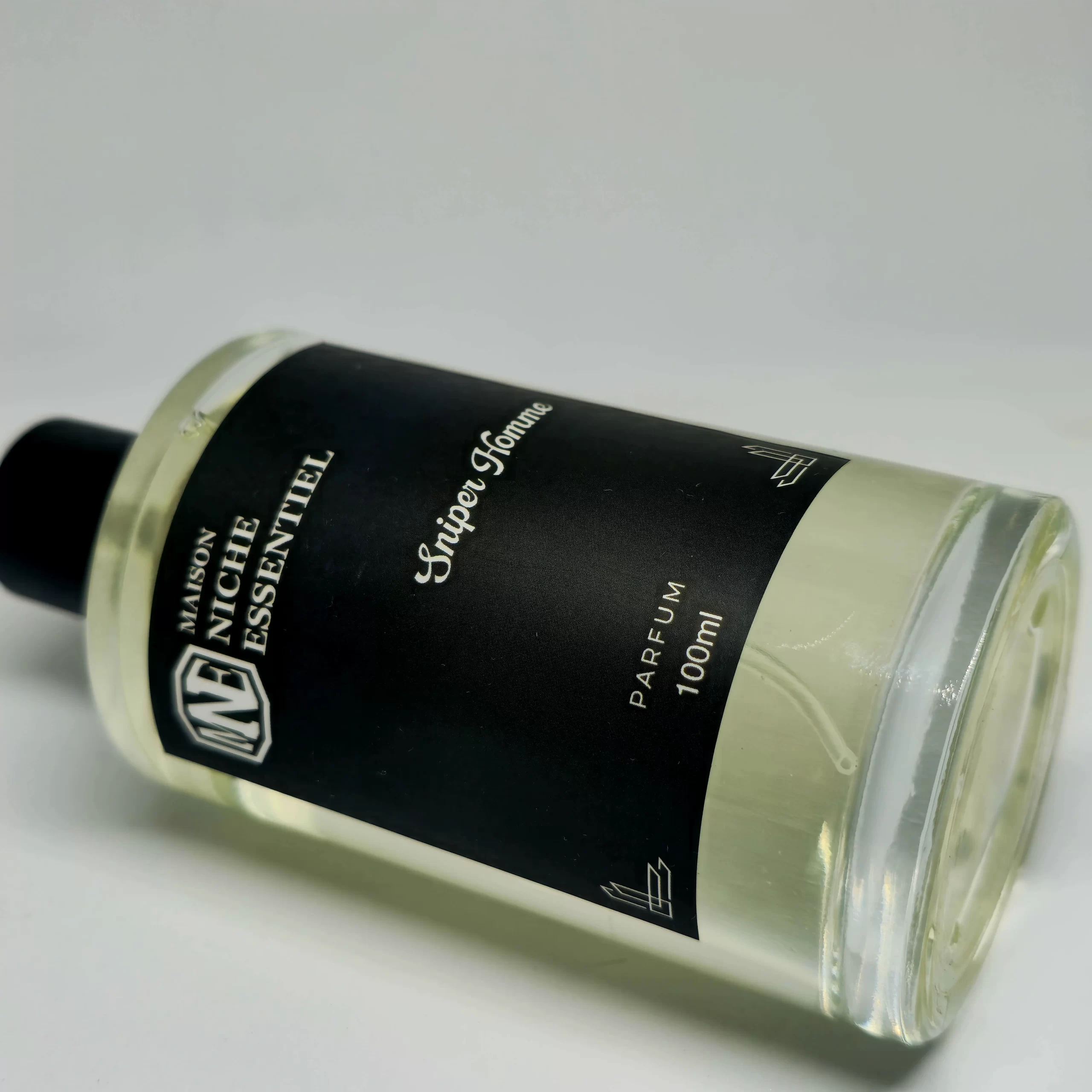 100ml bottle of Maison Niche Essentiel Spire Homme perfume with a black label.