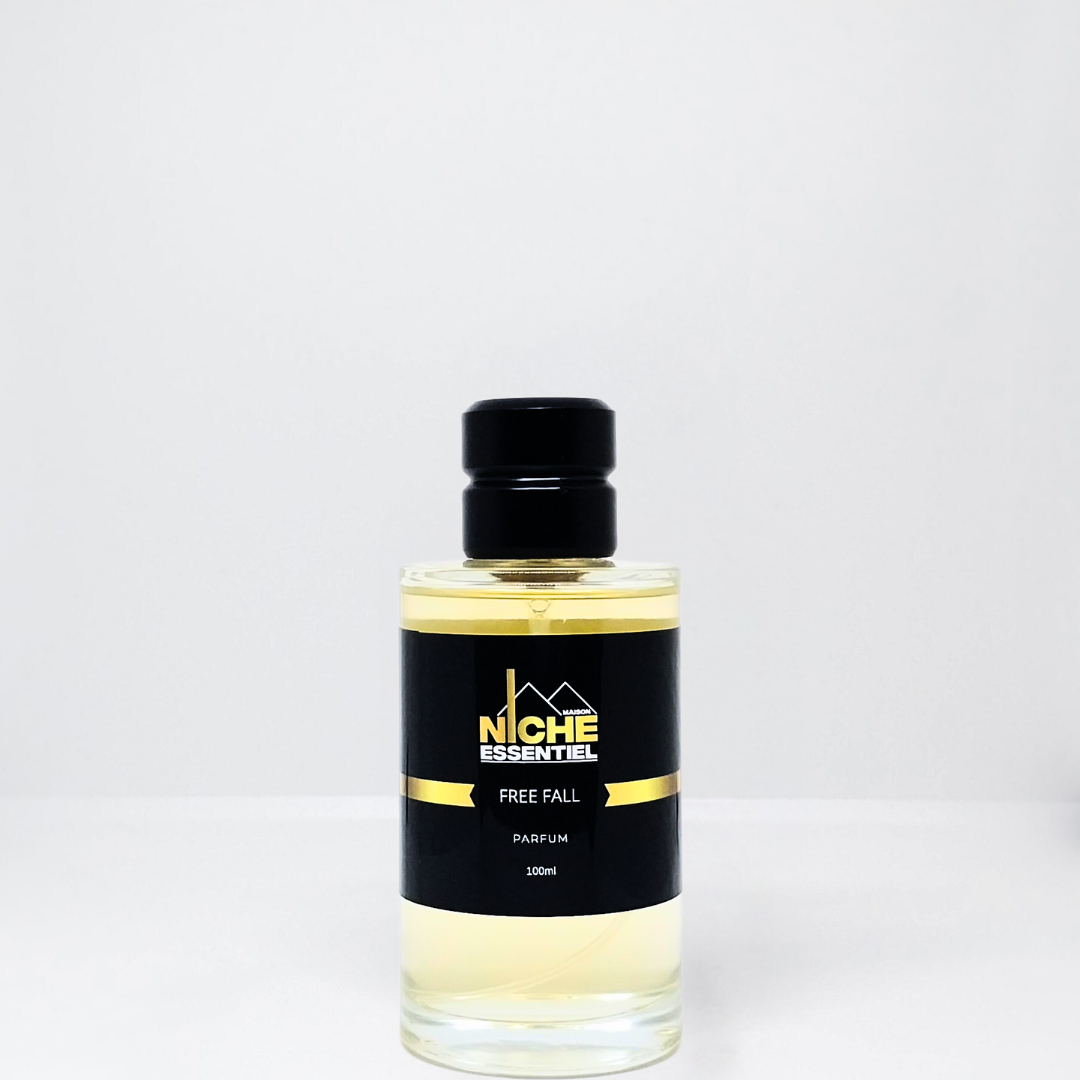 Clear glass bottle of Free Fall parfum with a black cap and label featuring the brand name Niche Essentiel.