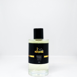 Clear glass bottle of Magnat Homme perfume with a black cap and label.